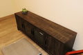 65" Media Console  Finish: Weathered Charcoal / Smoked Pine  ◦ Fits TVs up to 75" (Sturdy 135lb capacity)