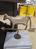 This vintage metal tabletop sculpture is a decorative cow weathervane