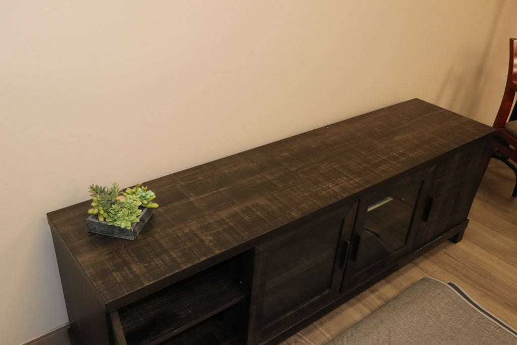 65" Media Console  Finish: Weathered Charcoal / Smoked Pine  ◦ Fits TVs up to 75" (Sturdy 135lb capacity)