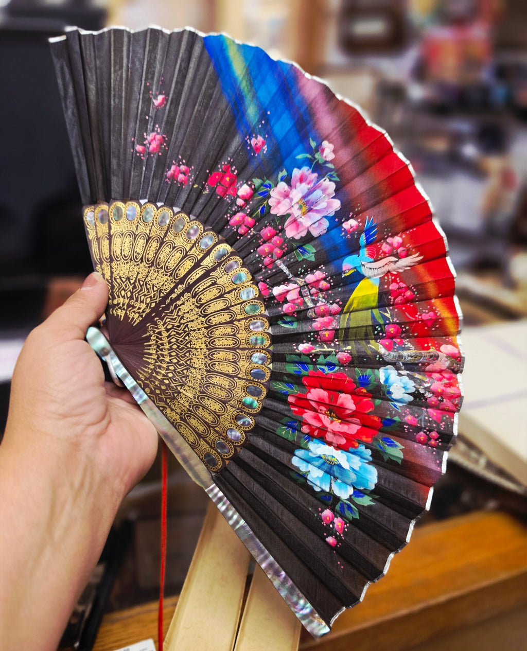 Vintage Mother-of-Pearl Hand-painted Mid Century Fan. In original box, accented in mother-of-Pearl and gold gilding with Premium  dark-stained wood staves